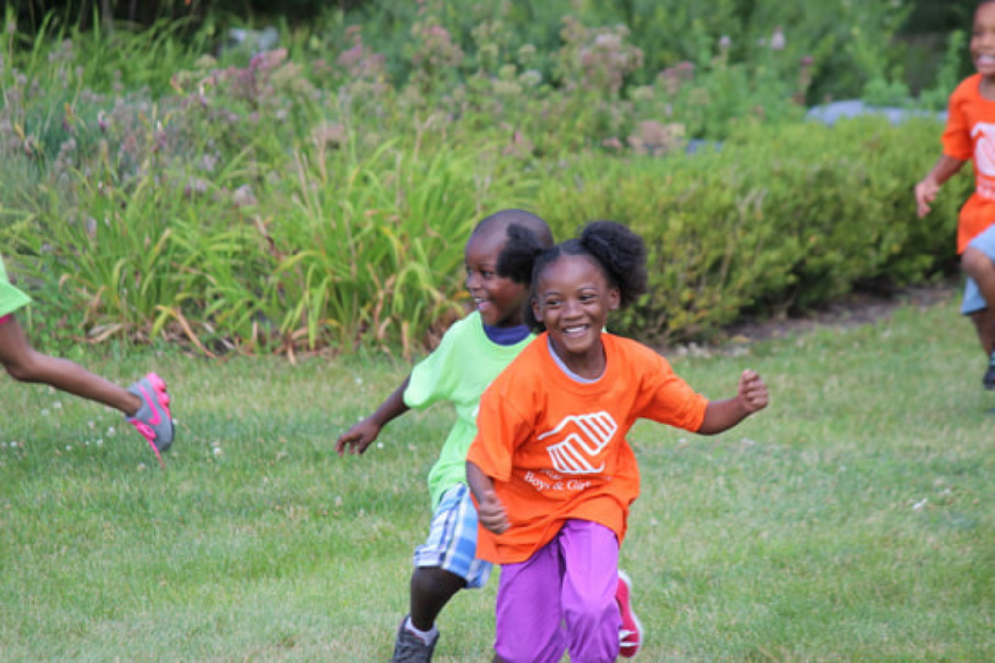 Kids running and playing outside during the Niagara Falls Boys & Girls Club summer program.