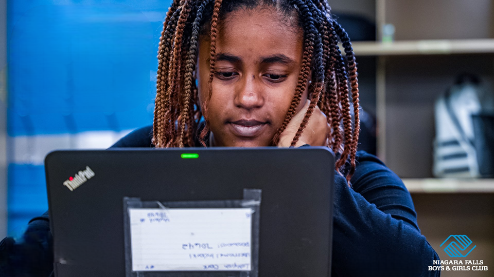 Student focused on a laptop during an educational program at Niagara Falls Boys & Girls Club.