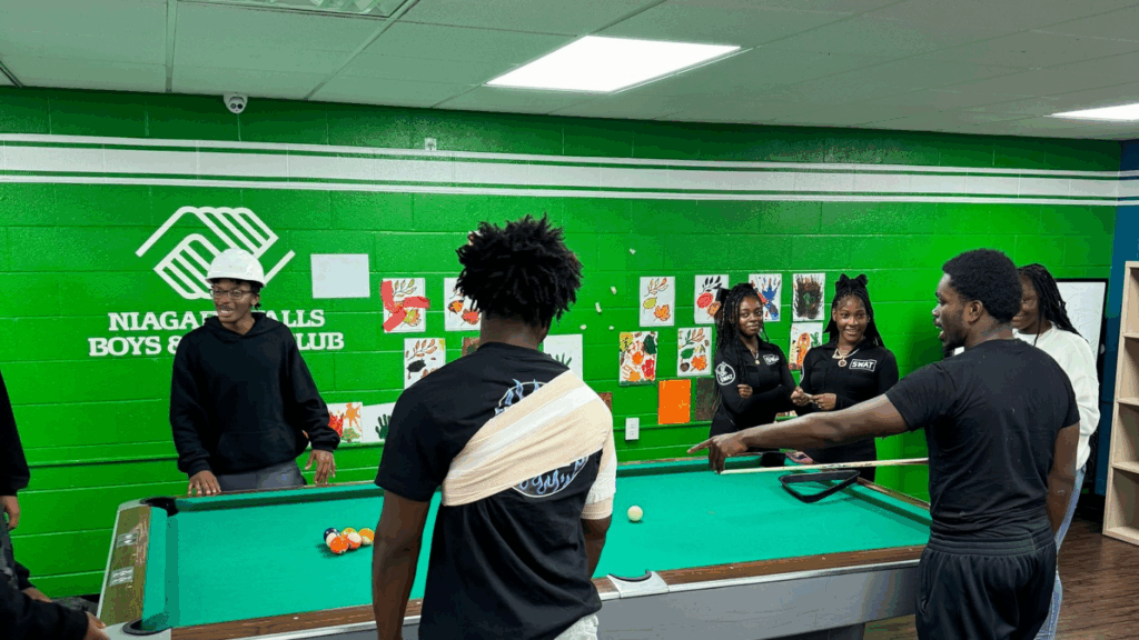 Teens playing pool in the Niagara Falls Boys & Girls Club game room, supported by community donations